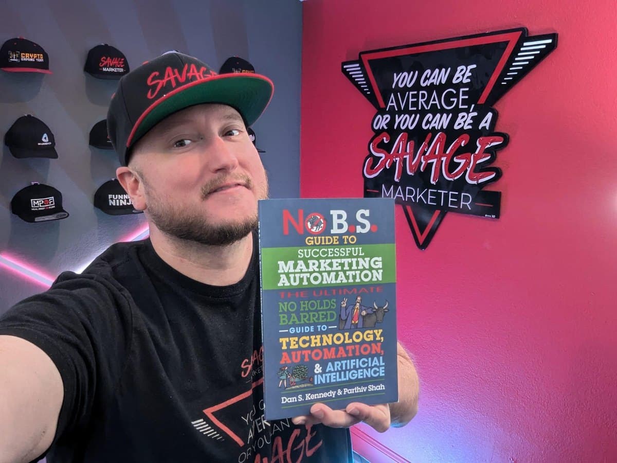 Jeff J Hunter holding Dan Kennedy's No B.S. Guide to Successful Marketing Automation, which features him