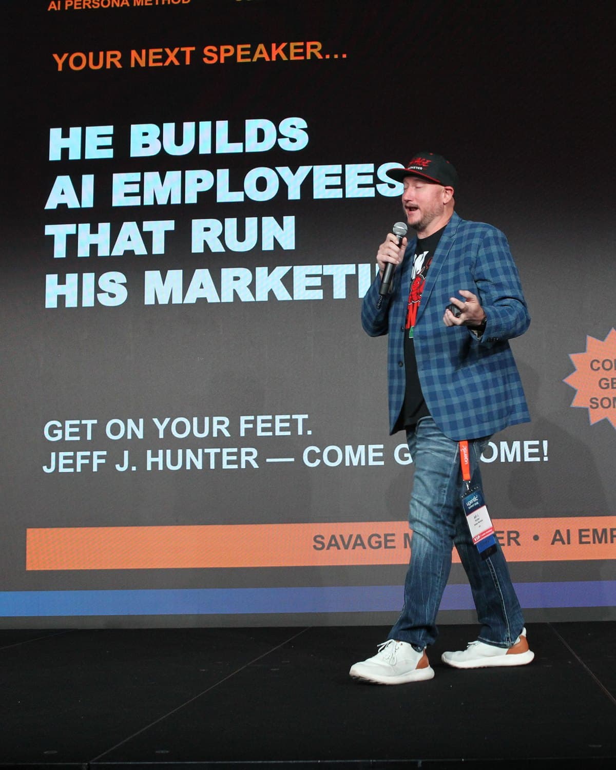 Jeff J Hunter on stage at the Ugentic AI Summit 2026 under a slide reading He builds AI Employees that run his marketing