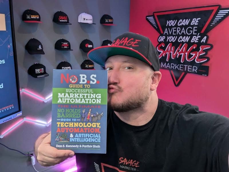 Jeff J Hunter holding Dan Kennedy's No B.S. Guide to Successful Marketing Automation